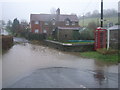 Brayford, telephone kiosk and road flooding