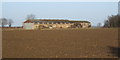 Ploughed field and farm outbuilding