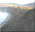 Slumping cliffs and sea defence wall at Nefyn Bay