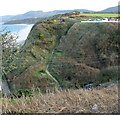 View east across Lon Bridin/Beach Road towards the cliff top path to Nefyn