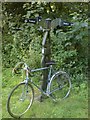 SN4905 : Bike leaning against cycle path mile post by Hywel Williams
