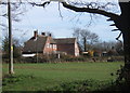 Looking across field to house in Milden