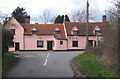 Looking directly at The Three Horseshoes pub from the end of Fossetts Lane