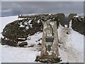 SD7381 : Whernside trig point and stile in the snow by John S Turner