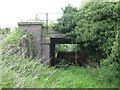 SJ7139 : Low railway bridge where the former Market Drayton to Stoke-on-Trent railway crosses the road to Bellaport Old Hall by Alan Wright