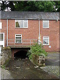 NY9364 : Cowgarth Burn emerging into Tanners Yard by Mike Quinn