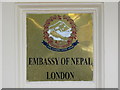 Sign on a gatepost of the Embassy of Nepal