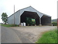 A John Deere harvester in a barn