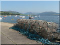 NS0767 : Port Bannatyne: lobsterpots on the pier by Chris Downer