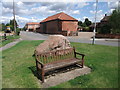 Seat and millennium stone on road through Shelford