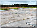 Concrete hardstand by airfield entrance