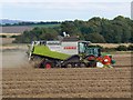 SU1078 : Combine and tractor north of Broad Hinton, Wiltshire by Brian Robert Marshall